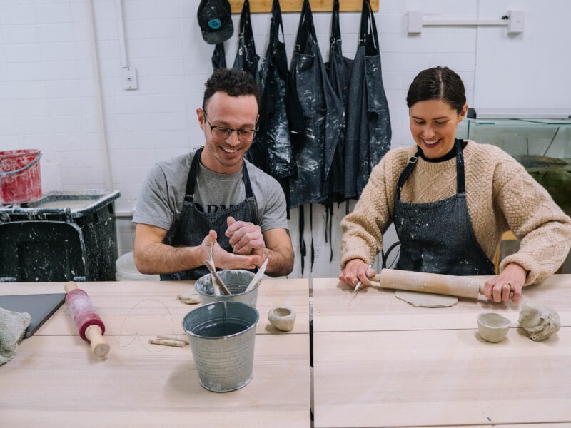 People hand building clay